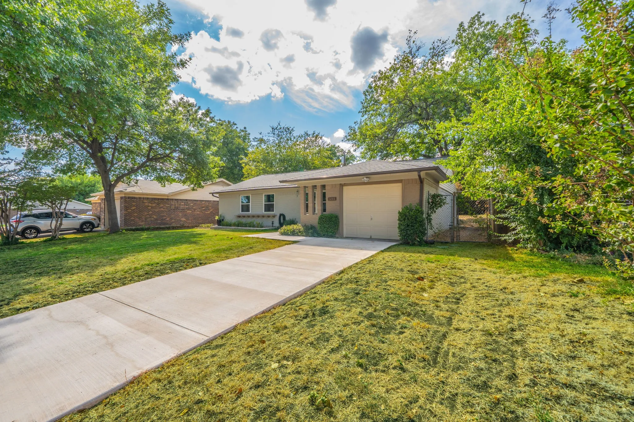 Single-story residence featuring a neutral-toned exterior, an attached single-car garage, and a concrete driveway