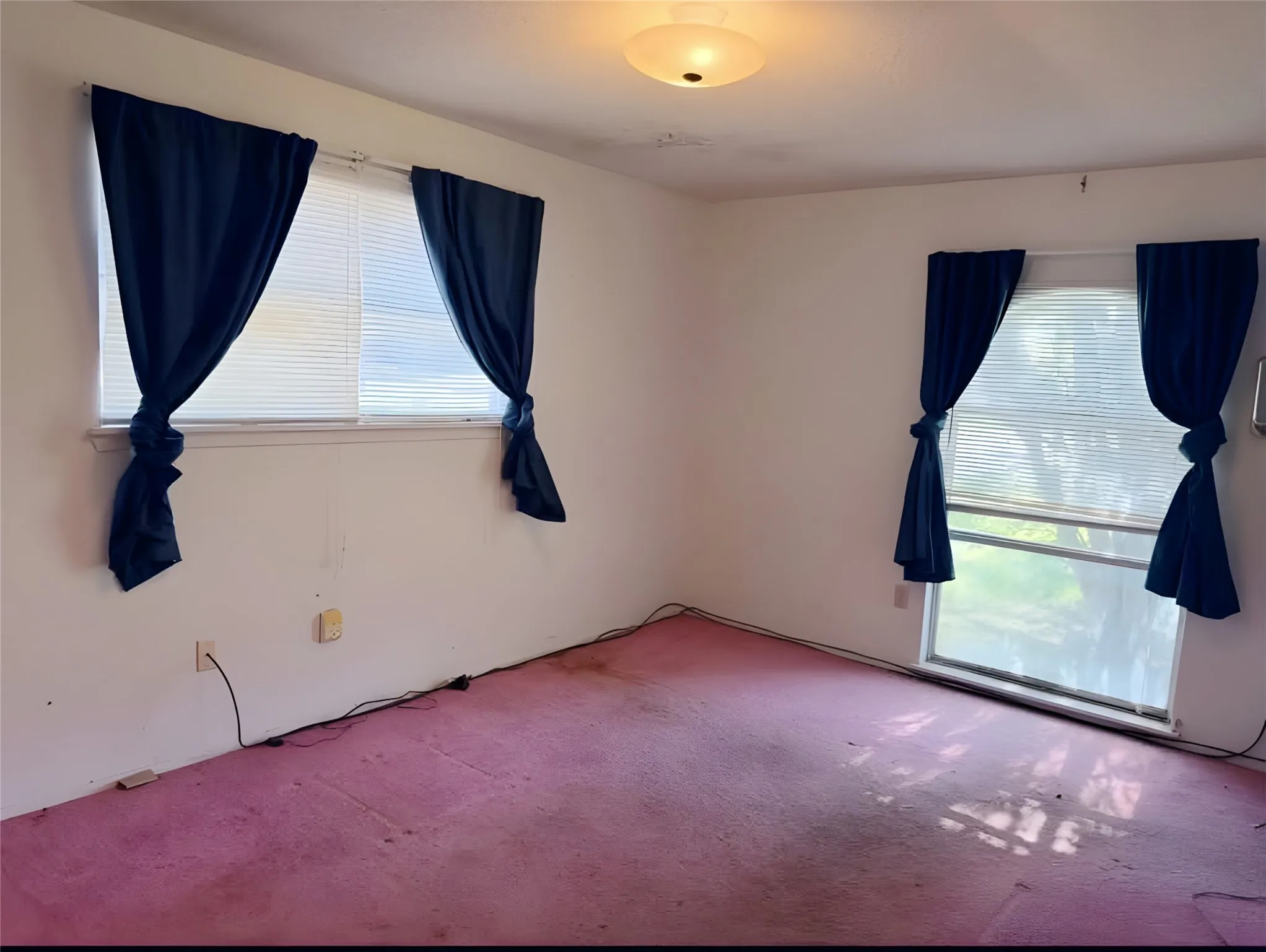  15 1/2 feet by 10 feet bedroom has a view of the mature crepe myrtle right outside the window.