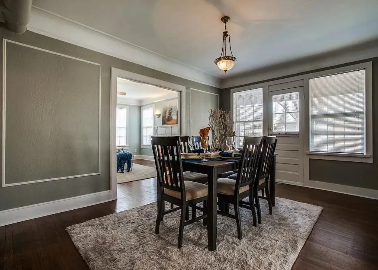 Dark wood-finish flooring complemented by a decorative ceiling light fixture