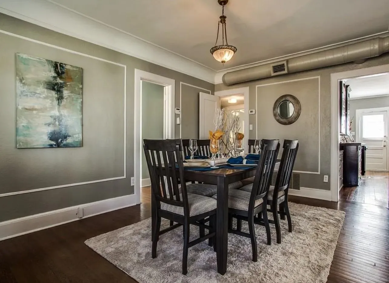 Hardwood-finish flooring, crown molding, chair rail molding, and a decorative ceiling light fixture