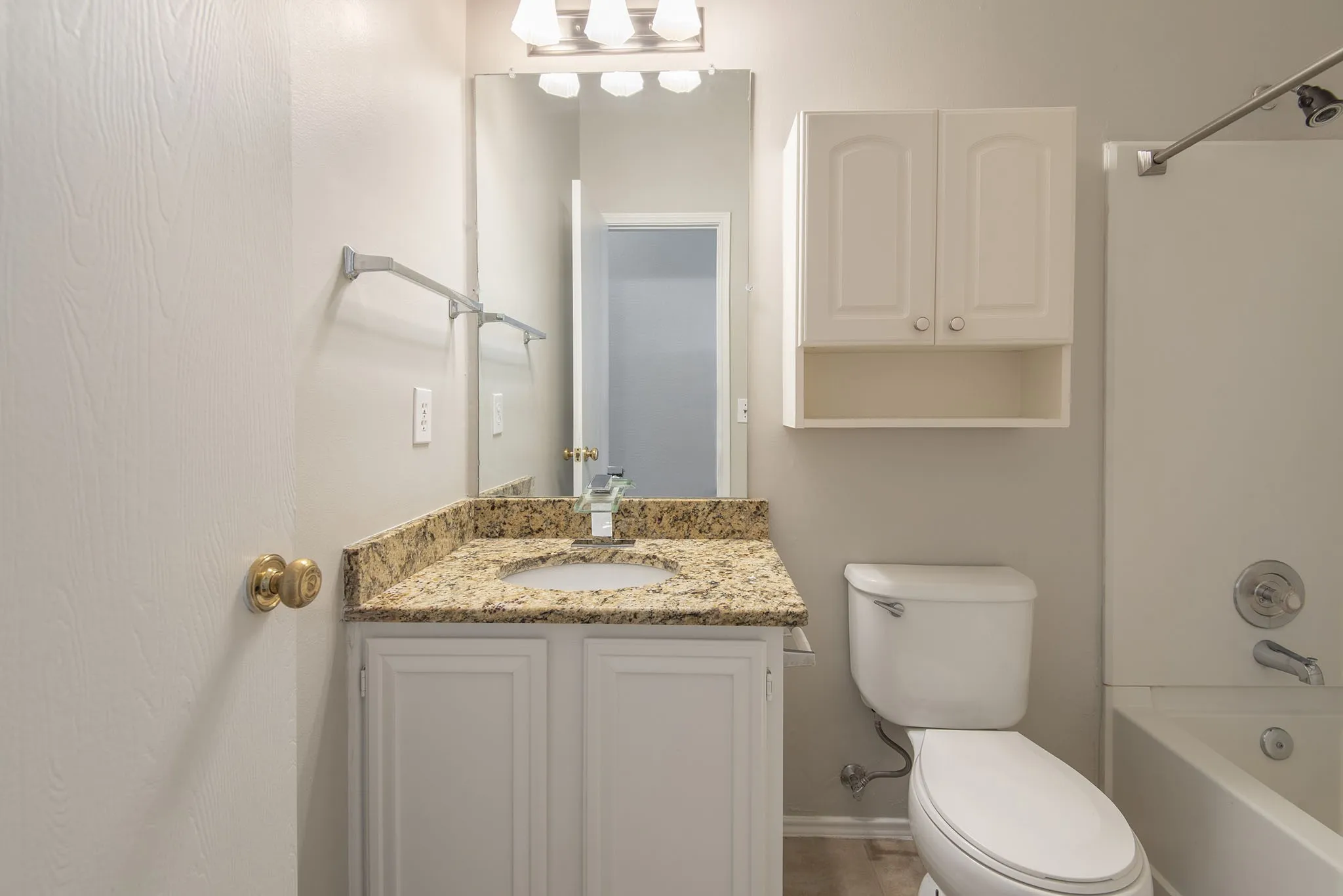 Vanity with a light-toned countertop, integrated sink, and undermount cabinetry
