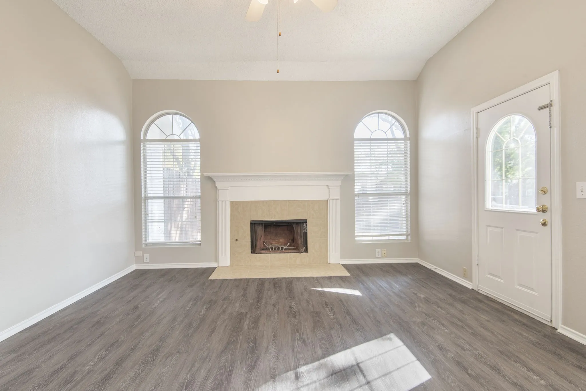 Vaulted ceiling and dark wood-finish flooring
