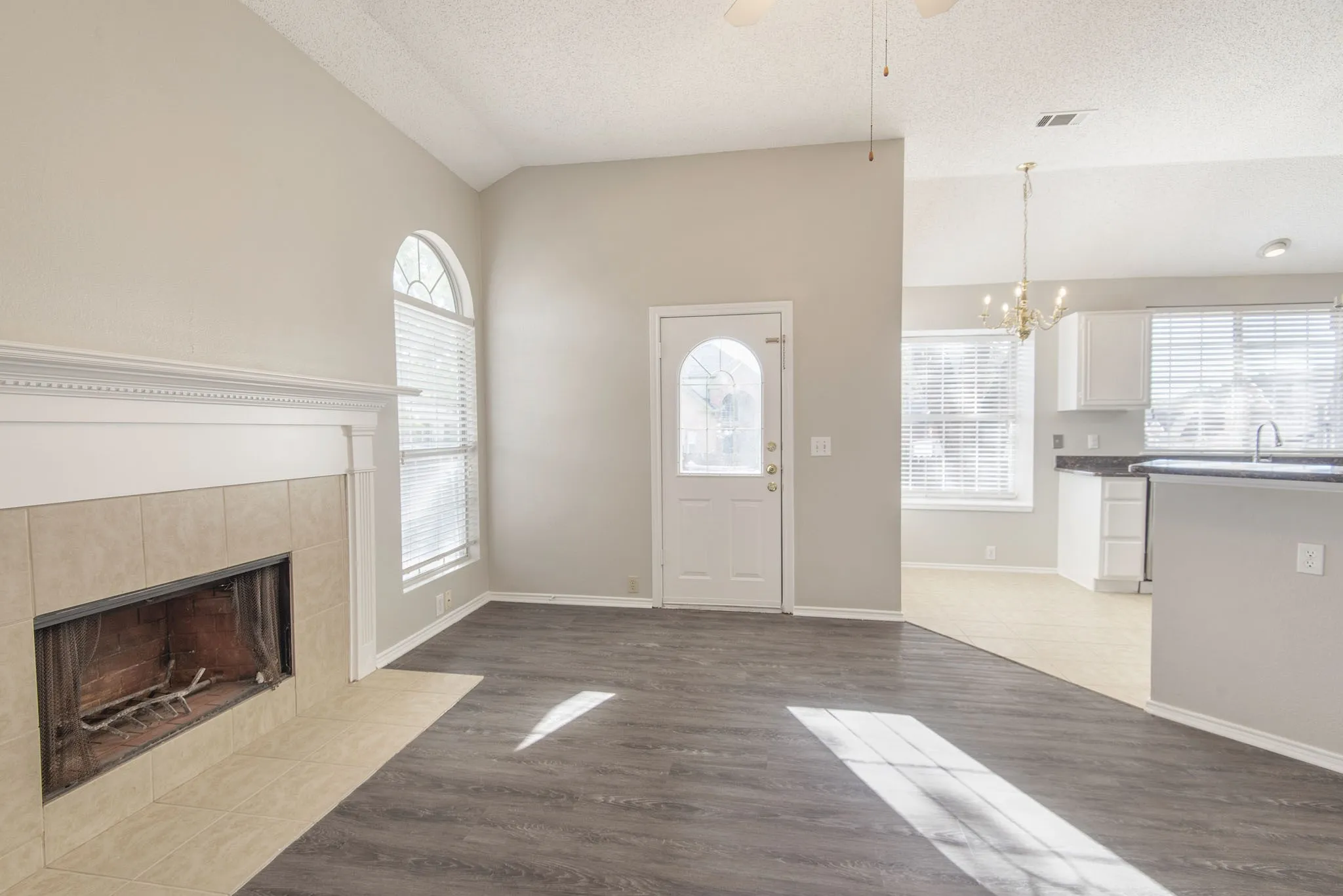 Vaulted ceilings complement the dark wood-finish flooring