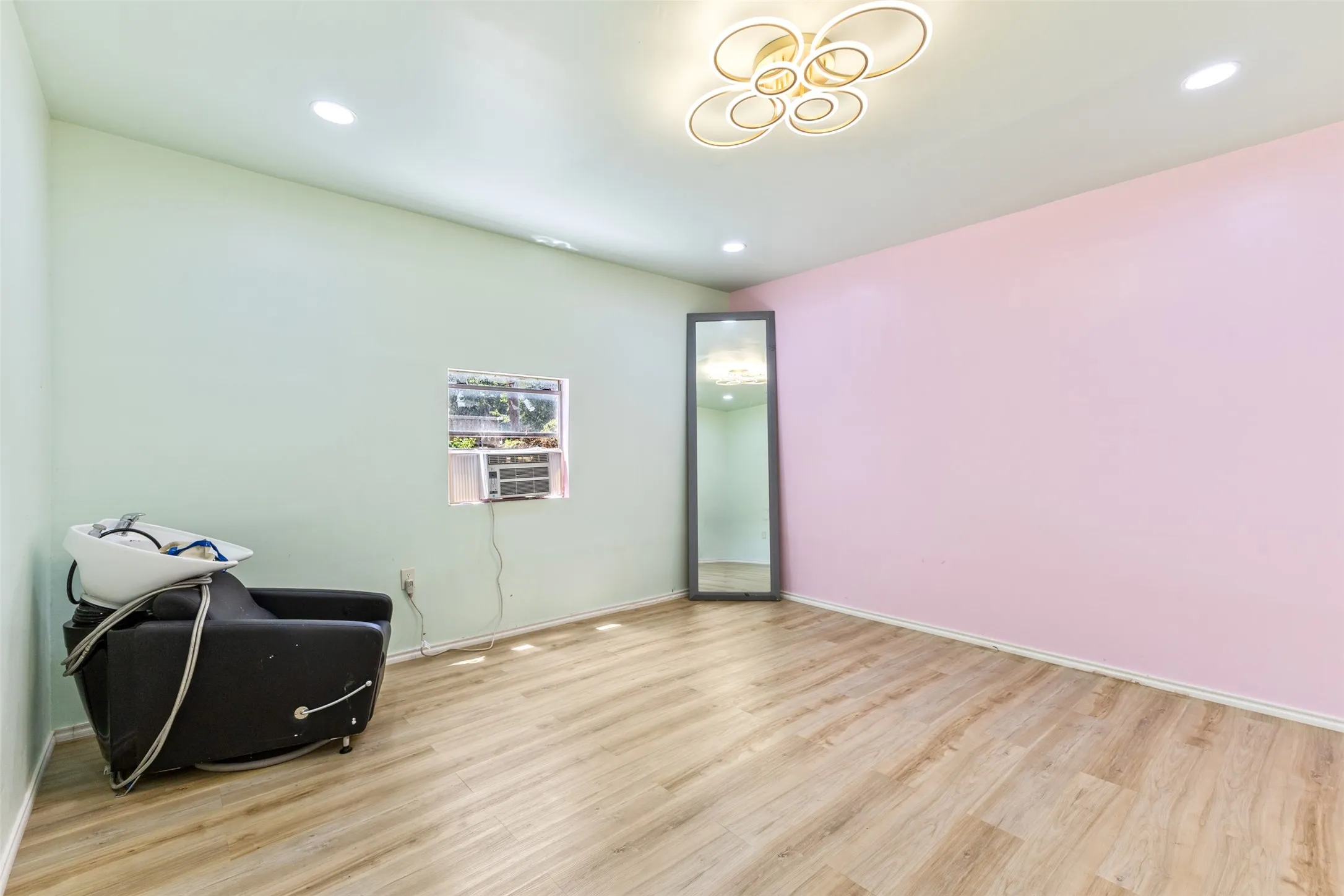 Wood-finish flooring, recessed lighting, and a modern ceiling fixture