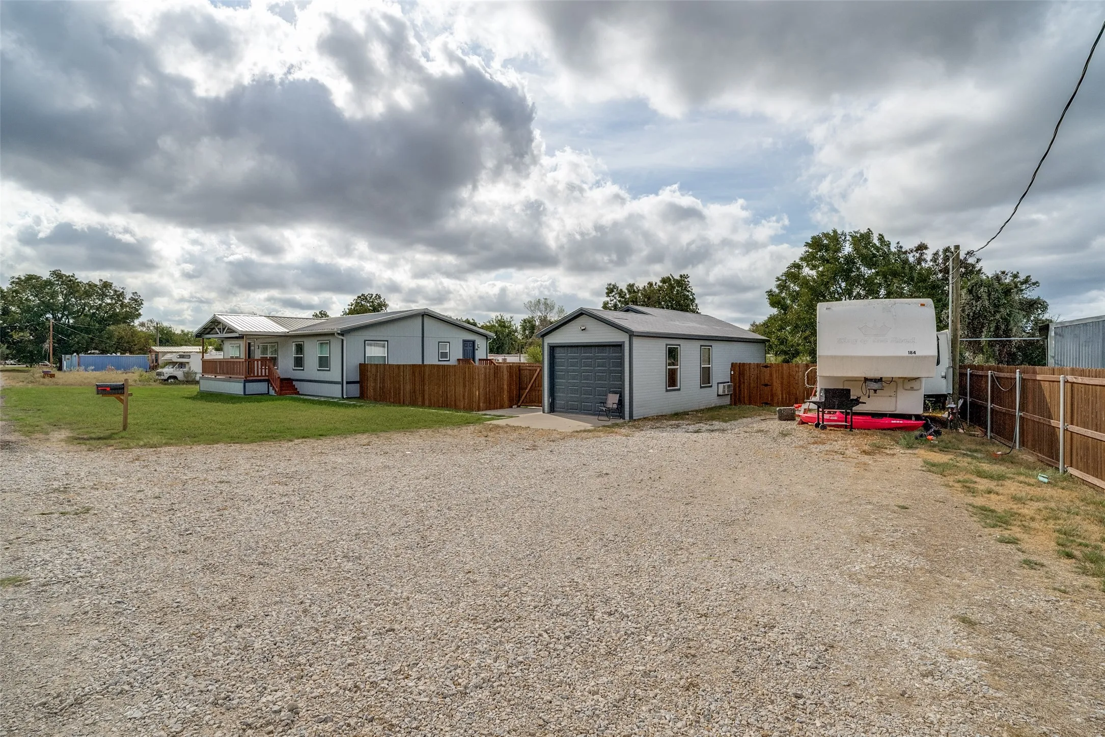 Gravel drive with detached garage and RV parking
