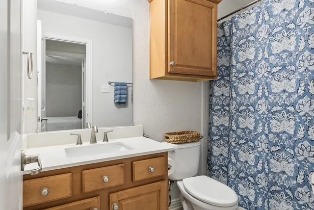 Vanity with a built-in sink, brushed nickel faucet, and wood-finish cabinetry