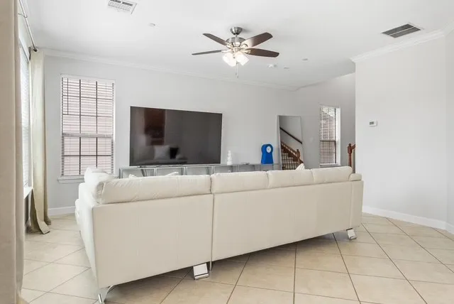 Recessed lighting, crown molding, ceiling fan, and tiled flooring