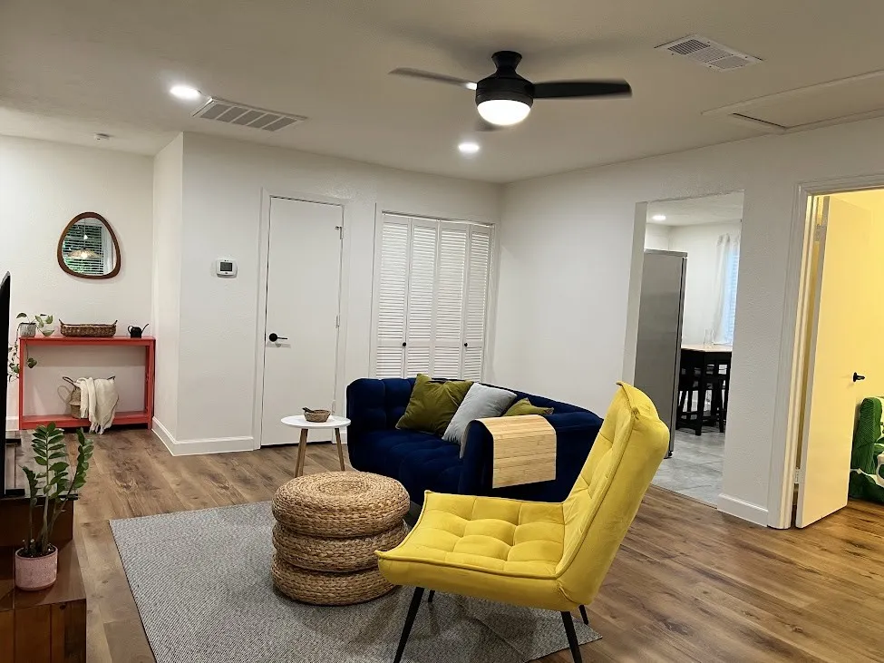 Wood-finish flooring throughout, with white walls and recessed lighting