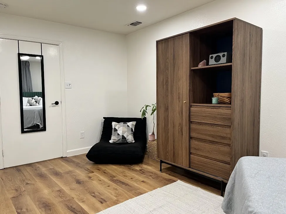 Wood-finish flooring with white walls and recessed lighting