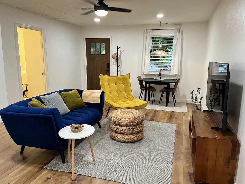 Wood-finish flooring, recessed lighting, ceiling fan, and a brown paneled entry door