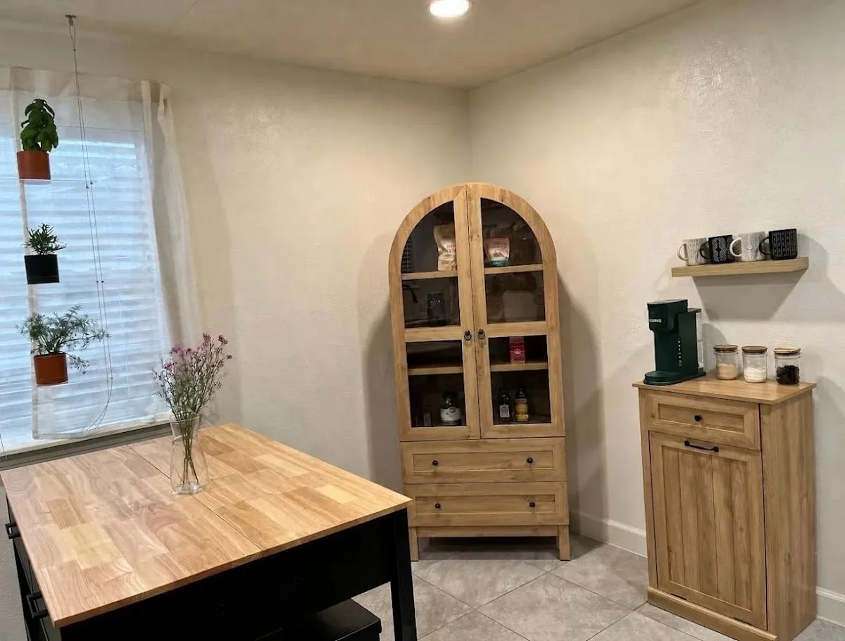 White walls and recessed lighting illuminate a room featuring wood-finish flooring