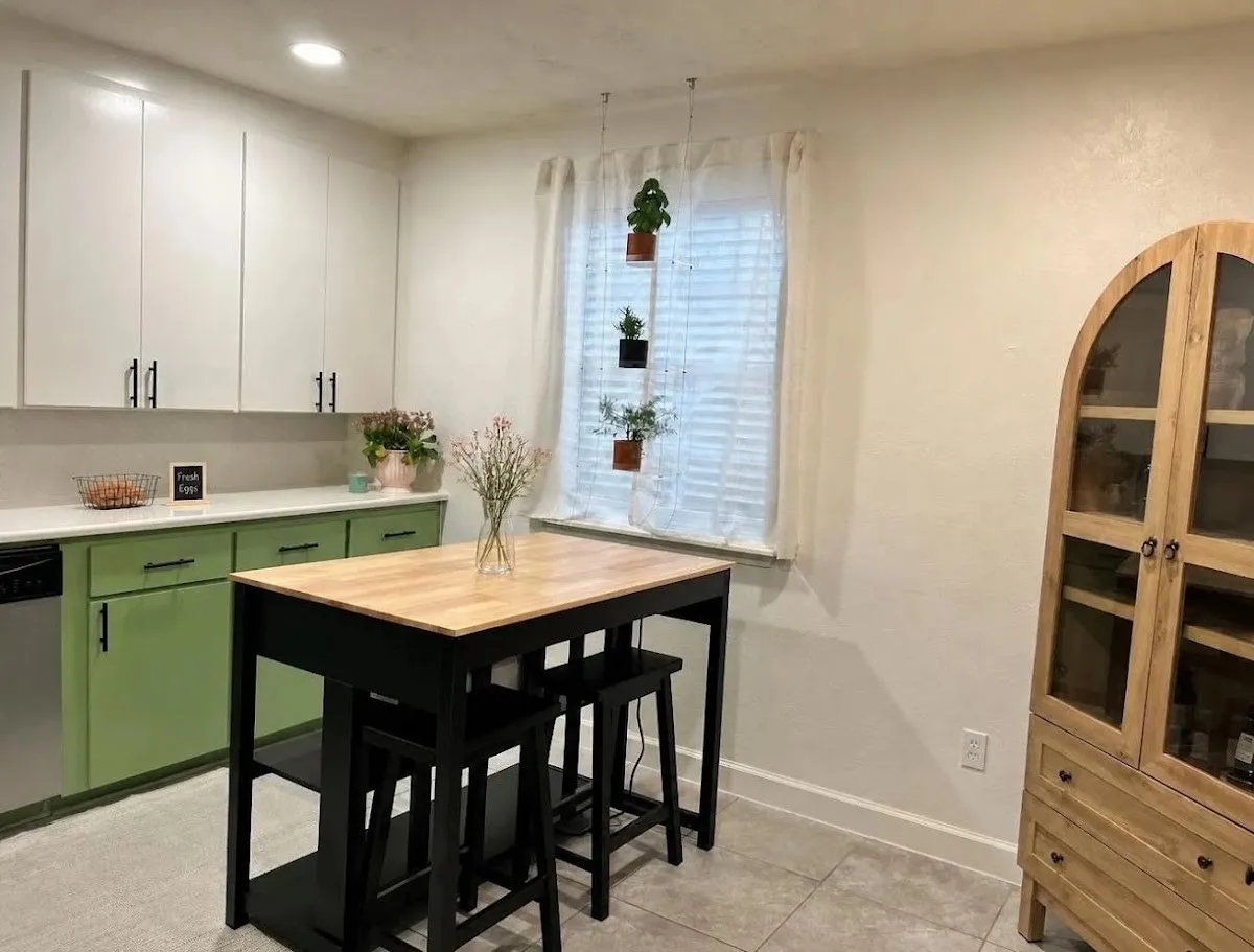 Kitchen featuring white upper cabinetry, green lower cabinetry, and a white countertop