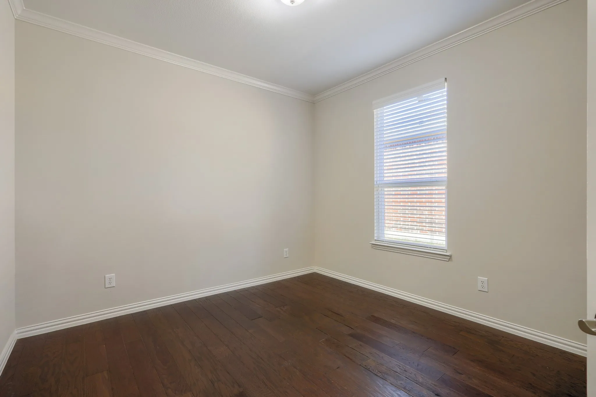 Recessed lighting illuminates the wood-finish flooring