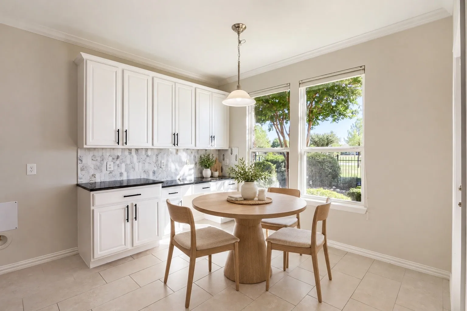 White shaker-style cabinetry with matte black hardware, Quartz countertops, and a patterned tile backsplash