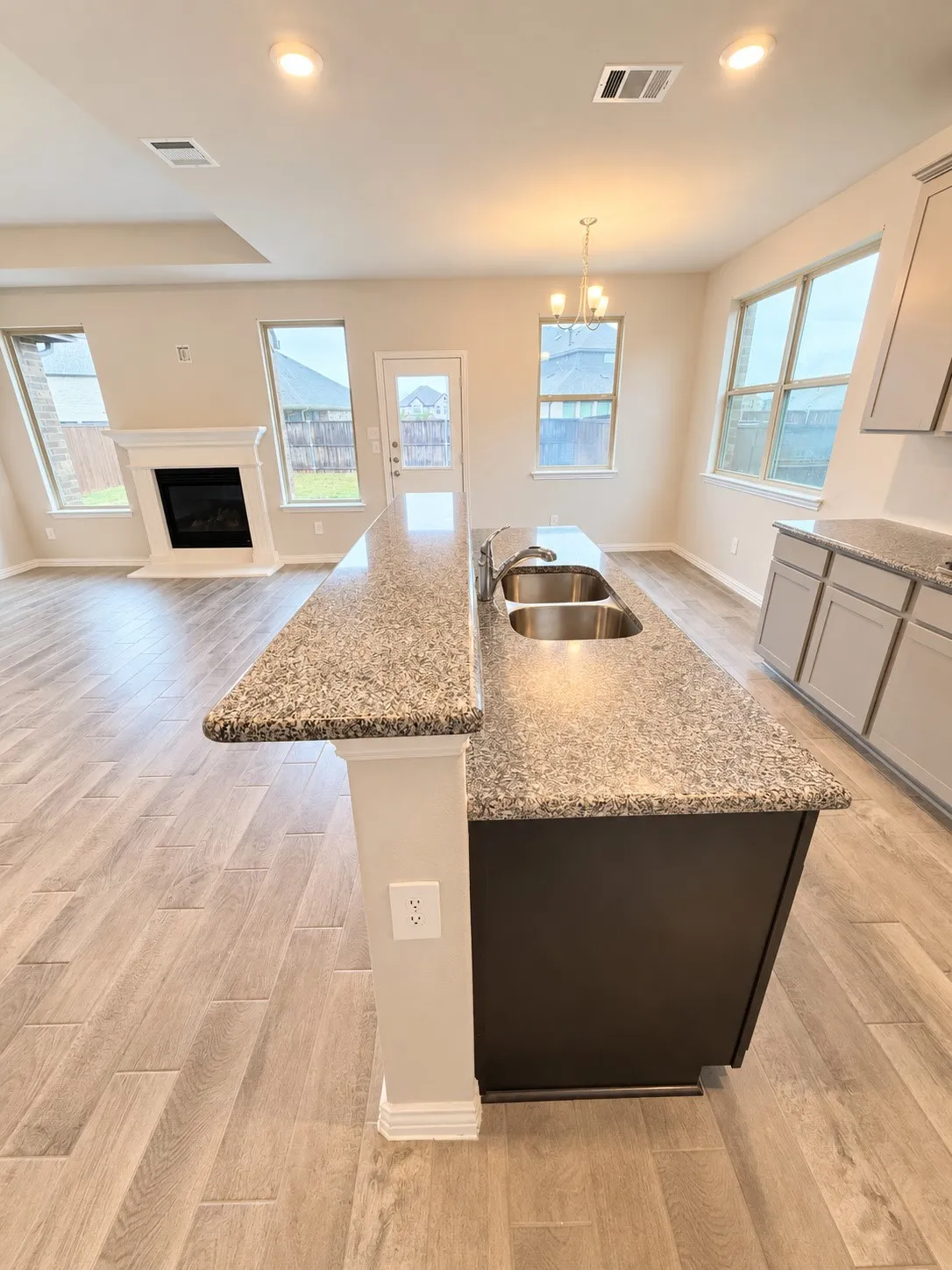 Kitchen island with an undermount double-basin sink, granite countertops