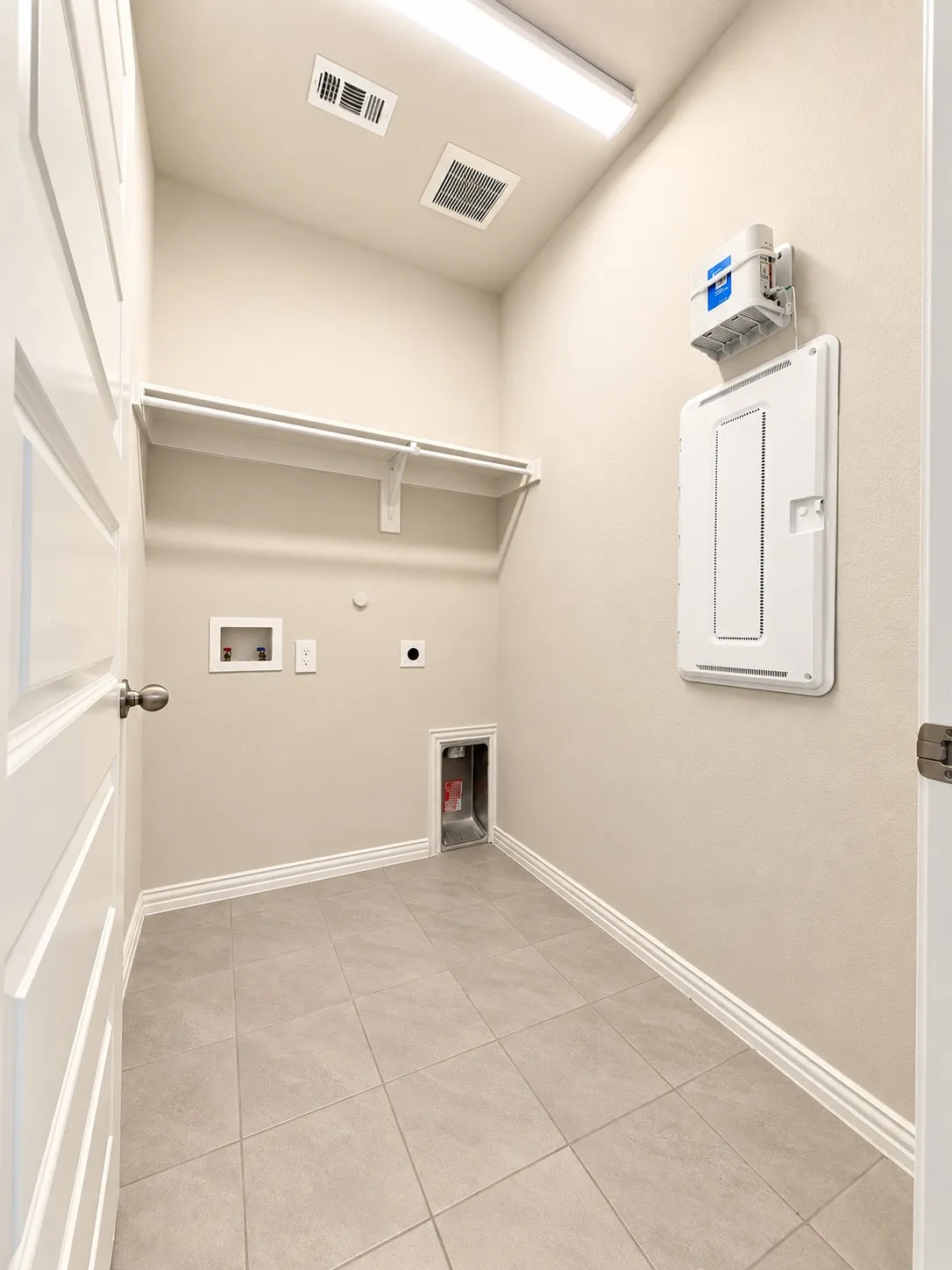 mounted shelving, built-in utility connections, and white baseboards
