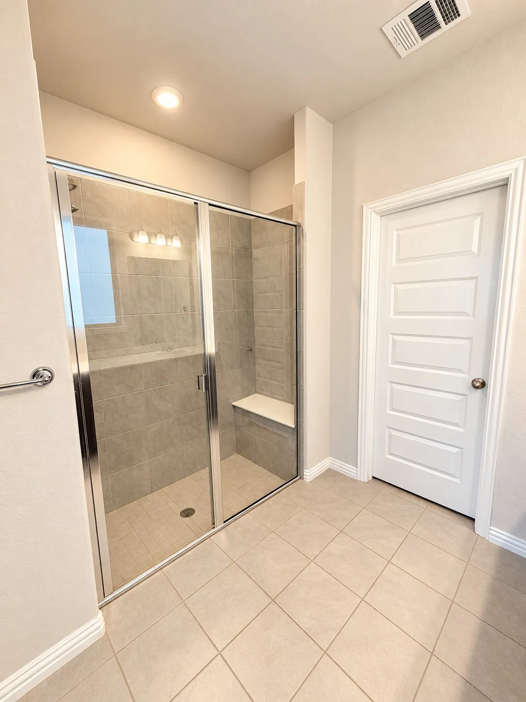 Expansive walk-in shower with a built-in bench