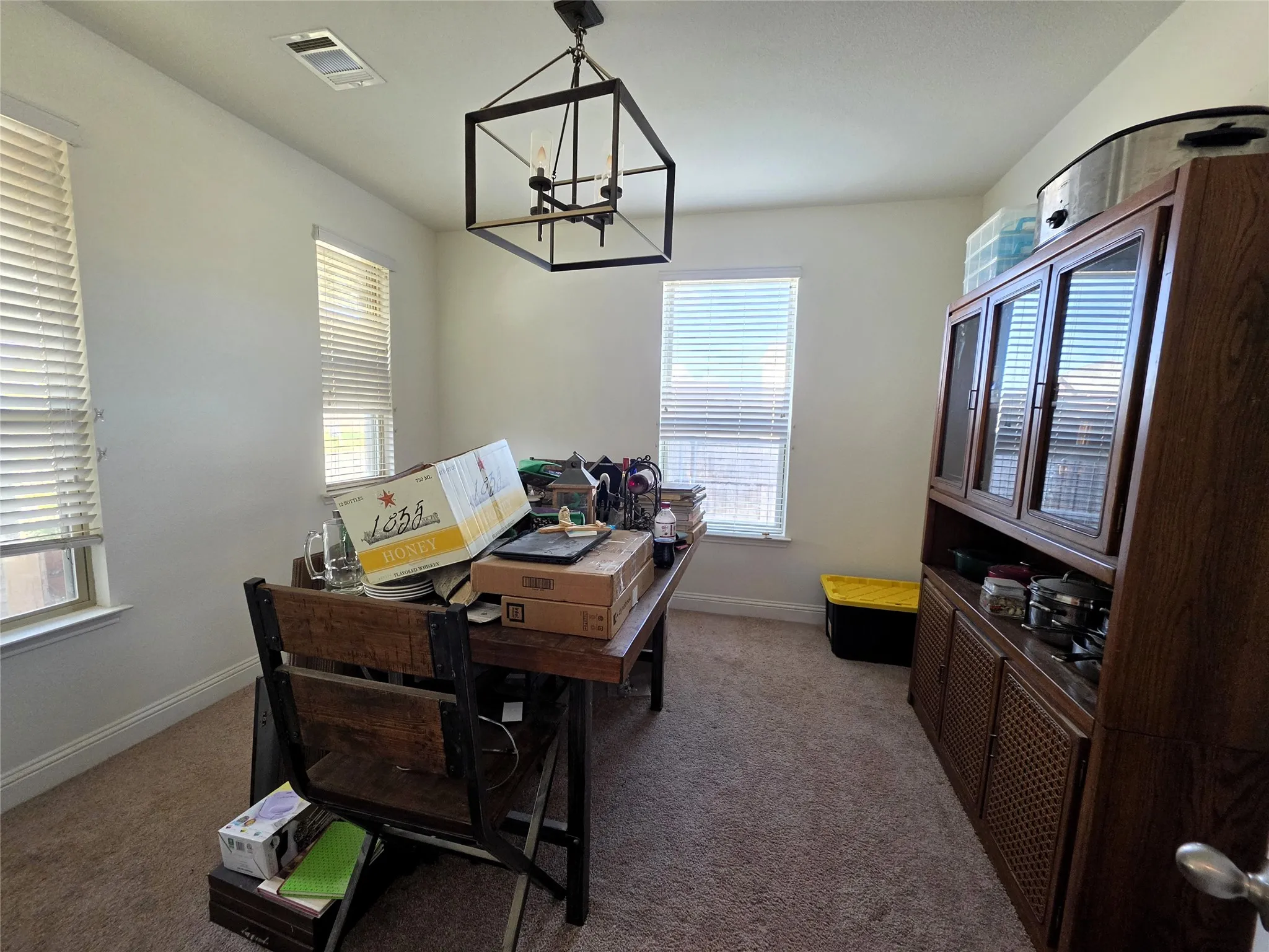 Recessed ceiling lighting, carpeted flooring, and a contemporary chandelier fixture