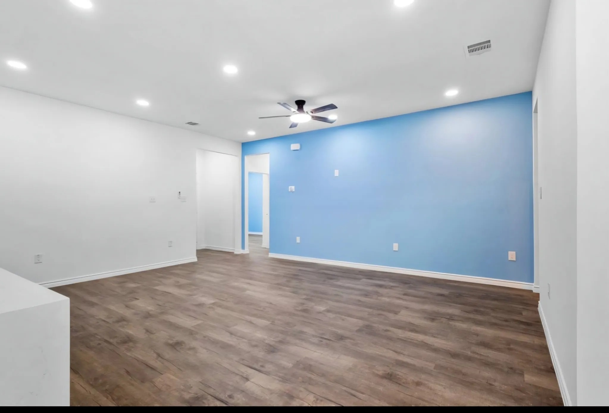 Recessed lighting, ceiling fan, wood-finish flooring, two-tone walls, and white trim