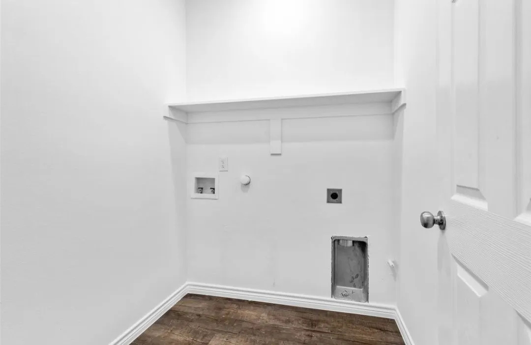 Built-in shelving, wood-finish flooring, and a paneled door