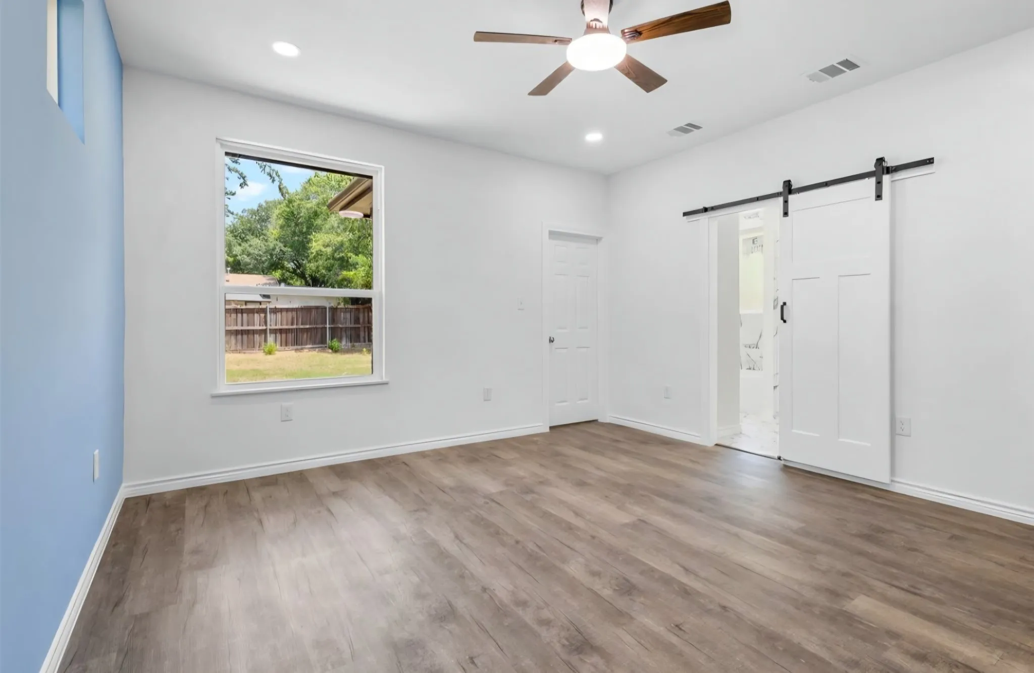 Wood-finish flooring, recessed lighting, and a ceiling fan