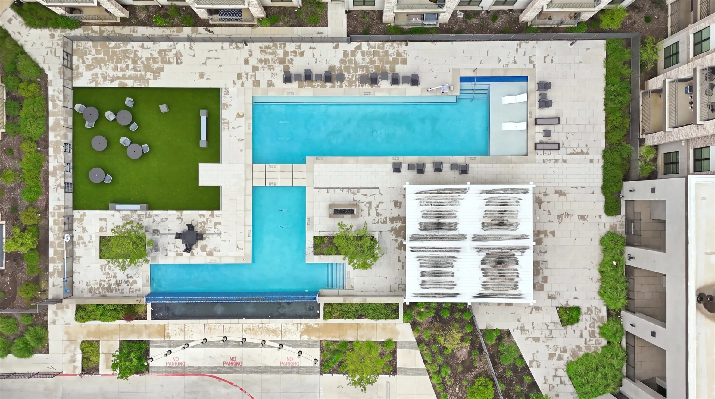 Expansive outdoor area featuring a swimming pool, sun deck, and artificial turf lounge
