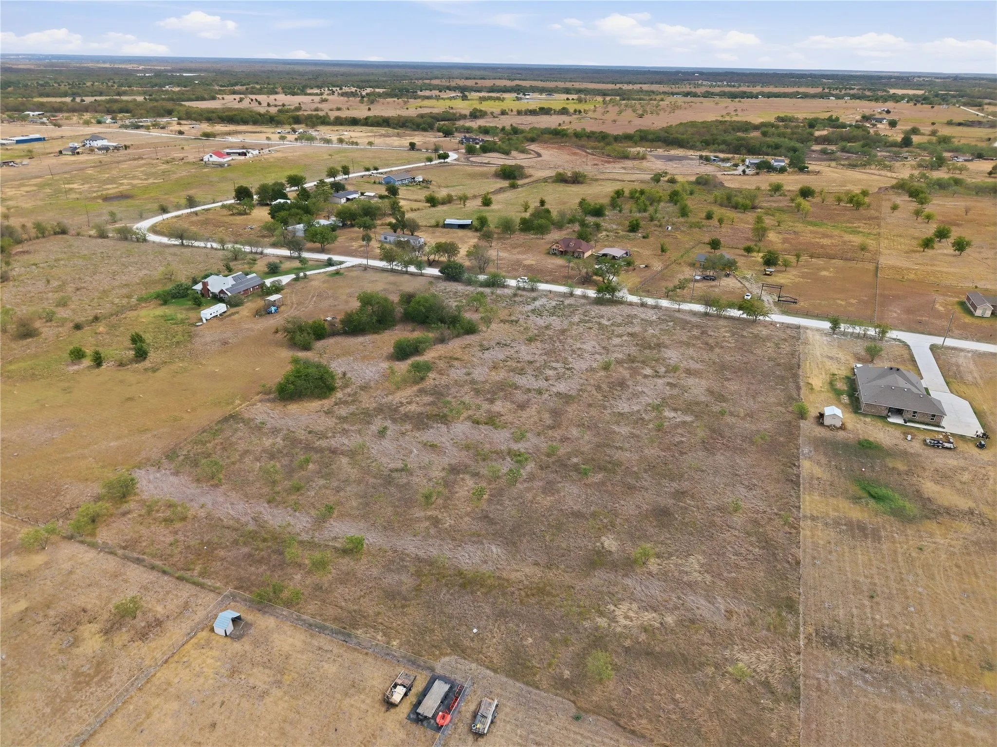 Expansive land parcel featuring natural vegetation and surrounding undeveloped areas