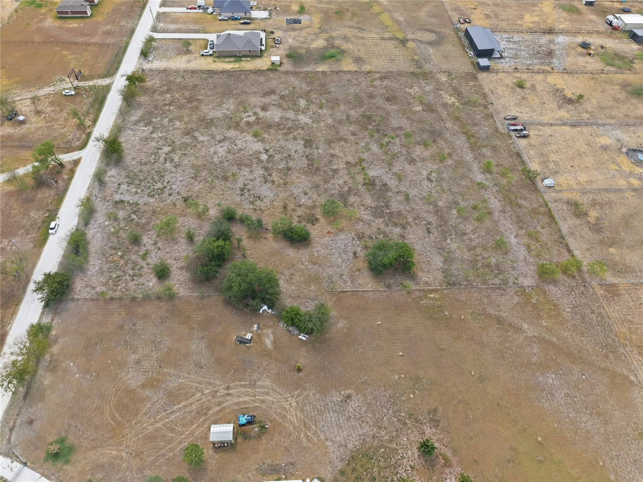 Expansive undeveloped land with visible road access
