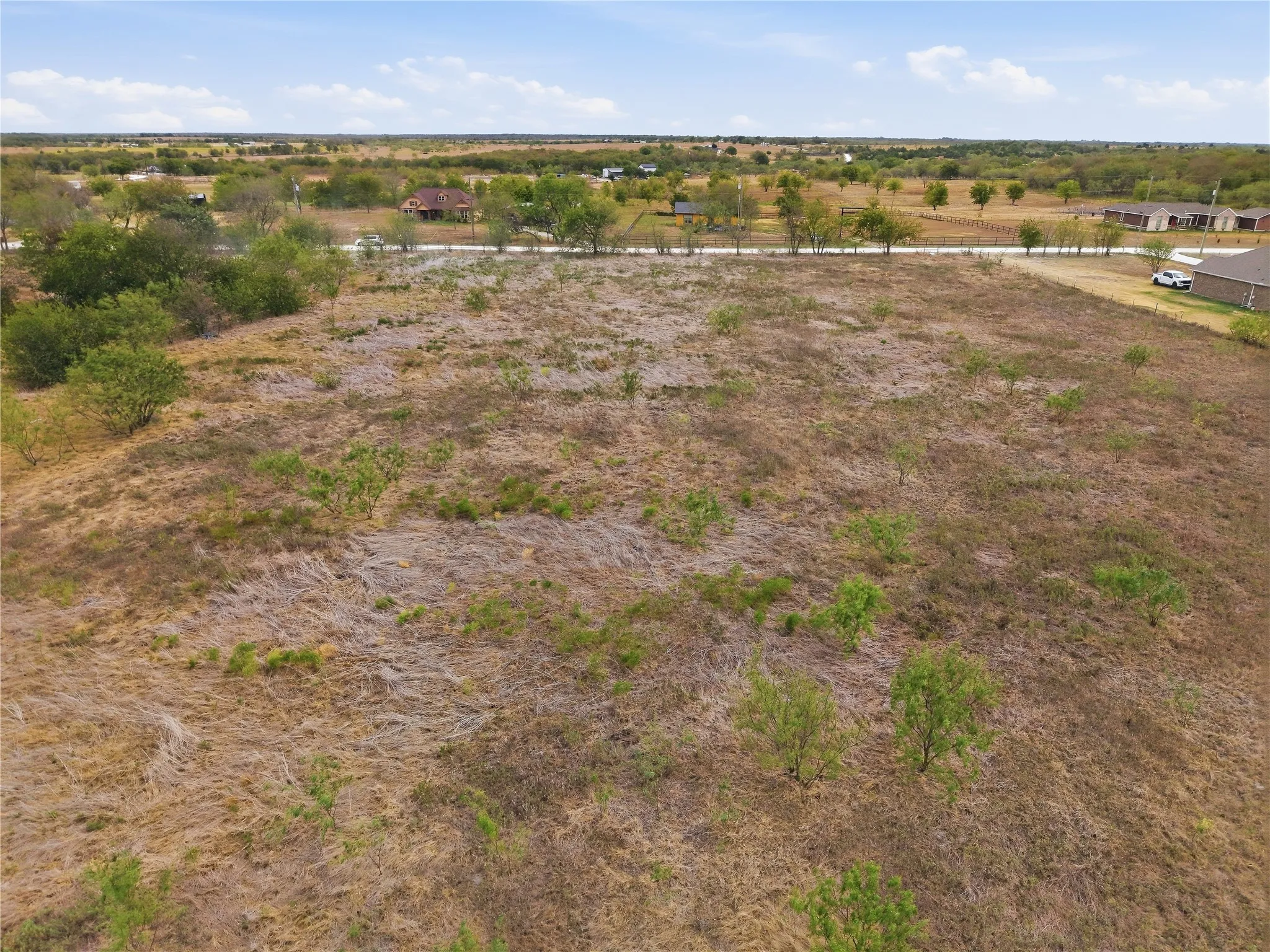 Expansive undeveloped land featuring natural vegetation and scattered trees