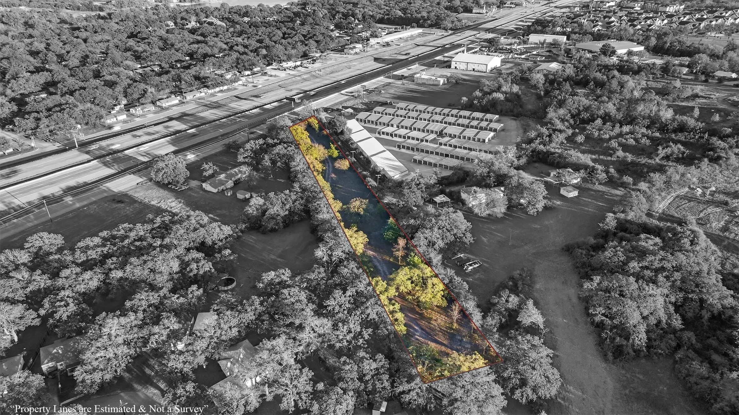 Expansive land parcel featuring a natural water body and surrounding mature trees
