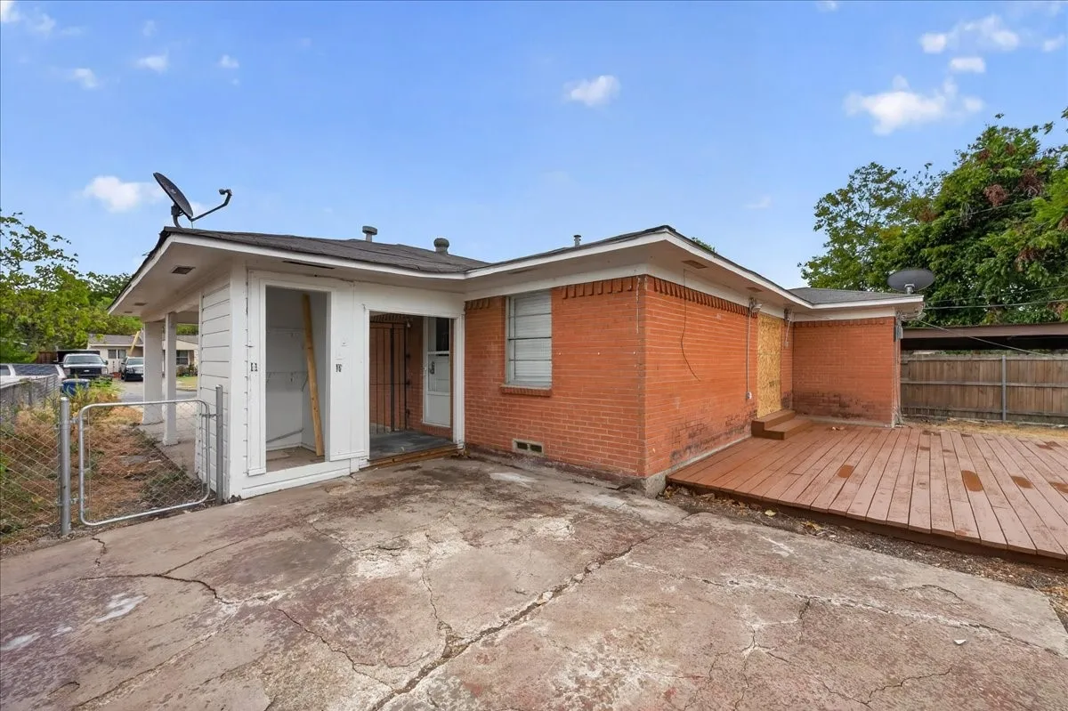 Brick exterior, wood decking, white siding, chain link fence, wood fencing