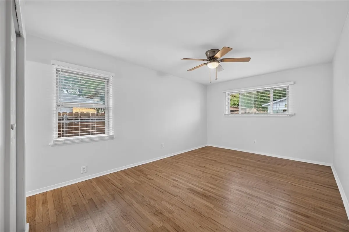 Hardwood flooring, painted walls, ceiling fan, and window​​‌​​​​‌​​‌‌​‌‌​​​‌‌​‌​‌​‌​​​‌​​ blinds