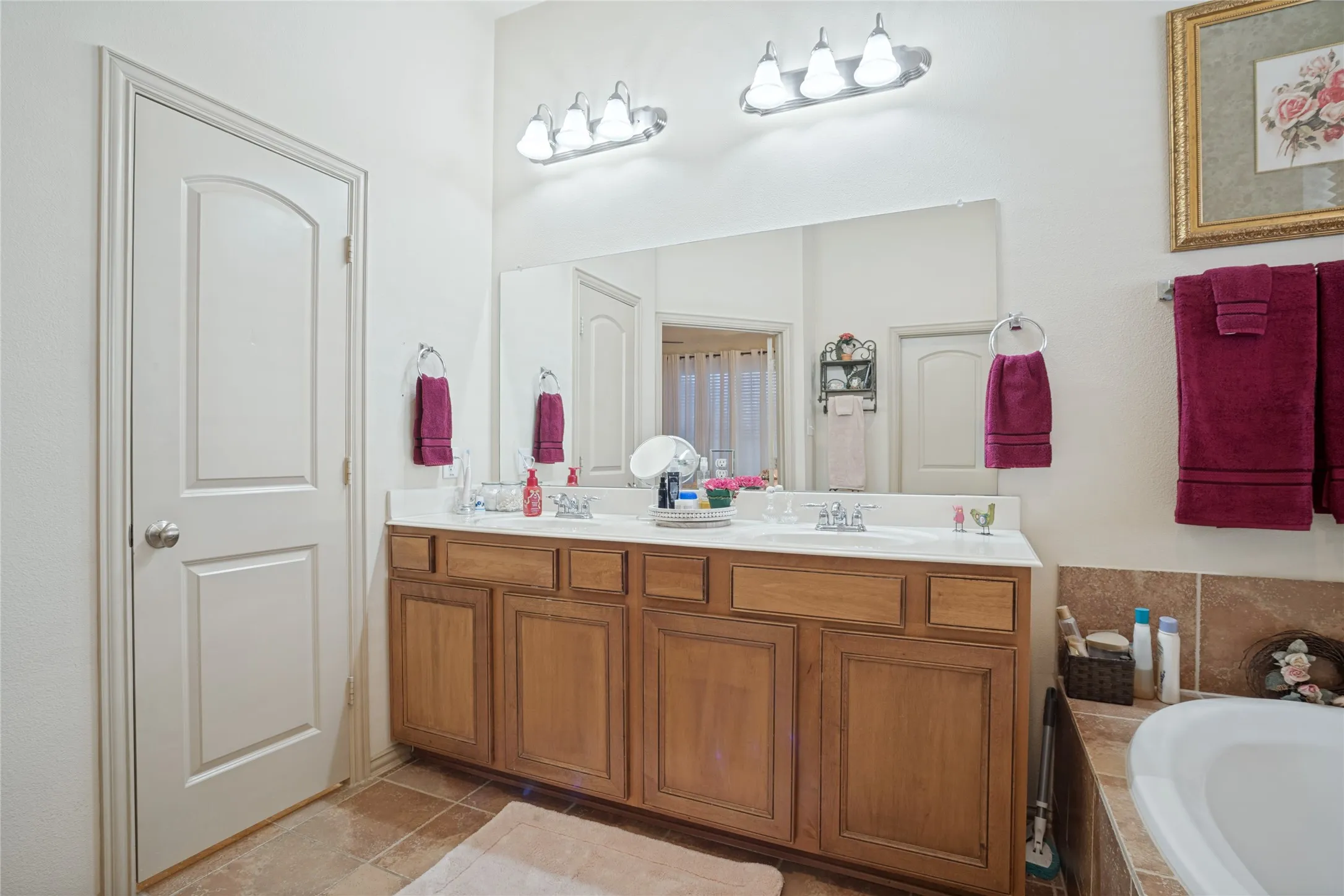 Designed for comfort and convenience, the primary bathroom features dual sinks, providing plenty of space for busy mornings and everyday routines.
