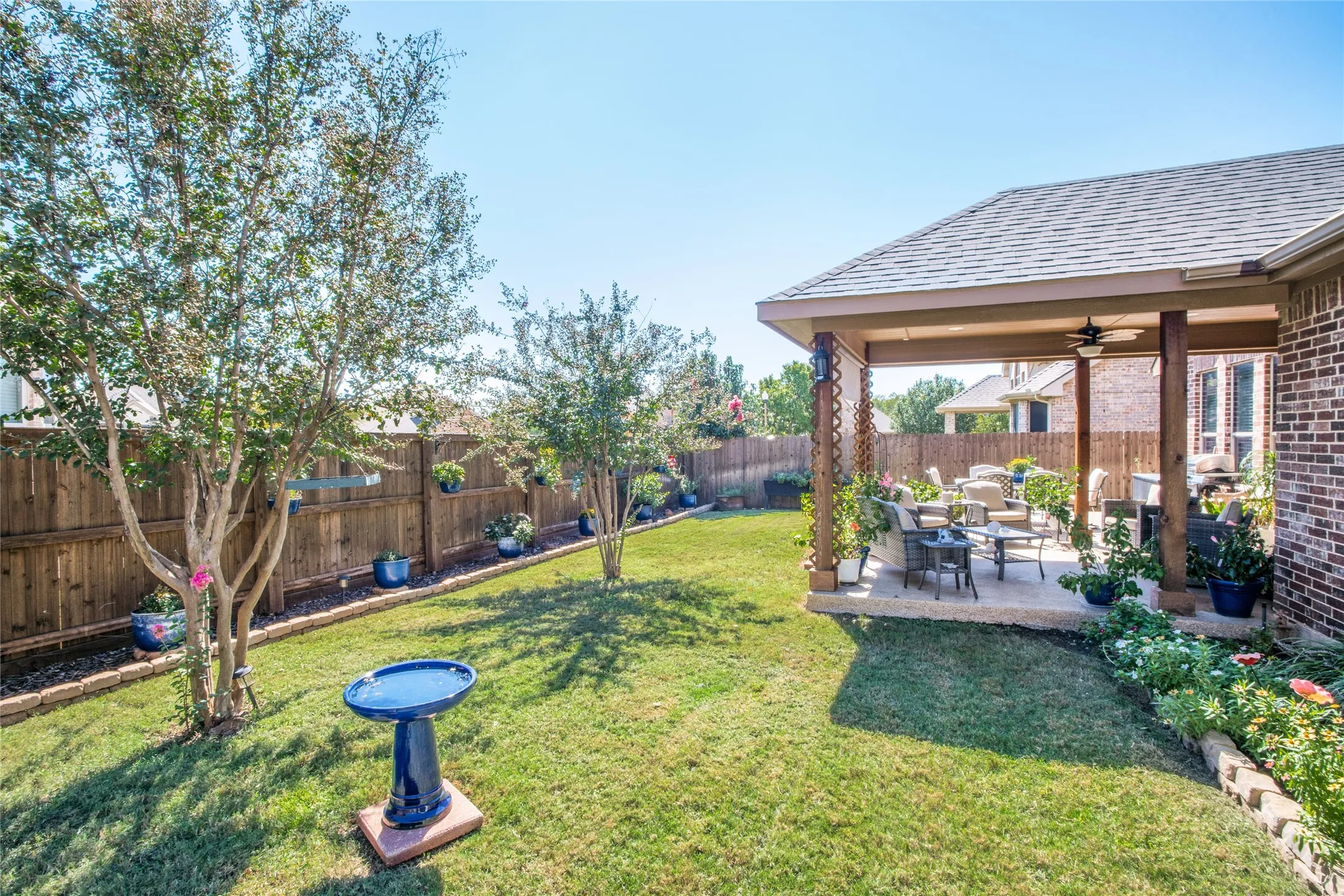 Beautifully maintained backyard and covered patio that is perfect for morning coffee or relaxing evenings.