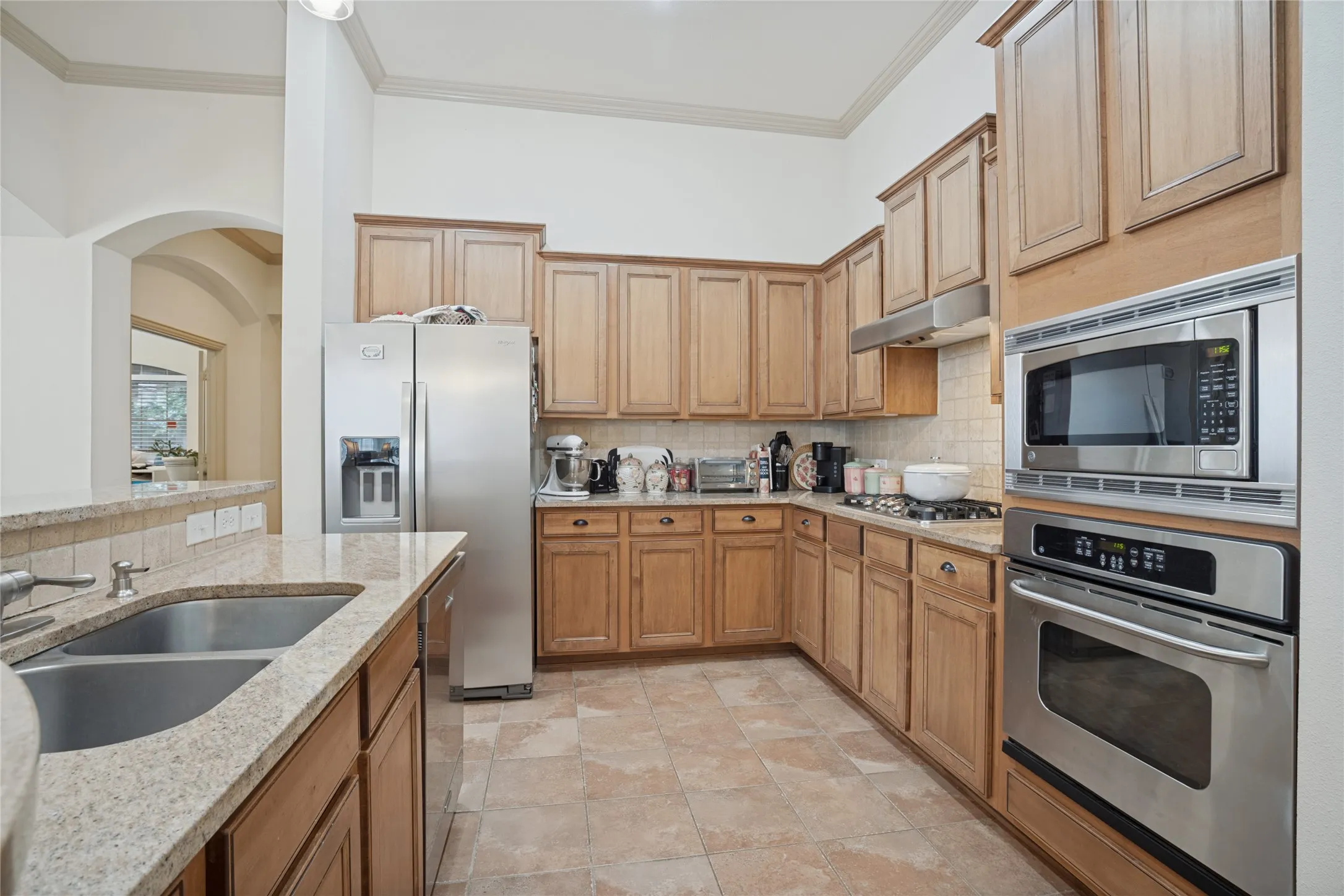 Stainless steel appliances and abundant counter space make meal preparation a breeze, offering plenty of room for the cook of the household to create and entertain.