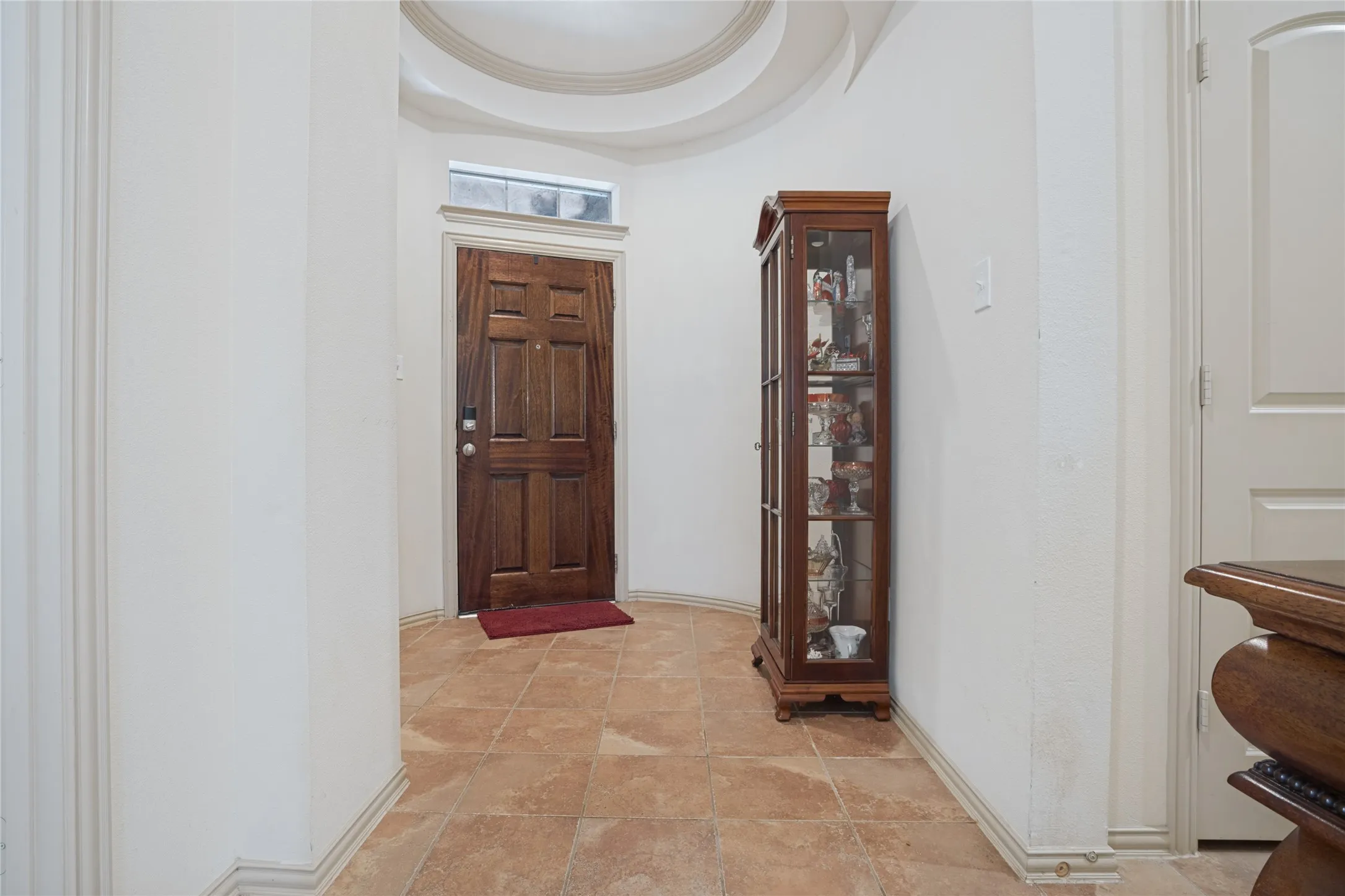 A warm and inviting foyer welcomes you inside, setting the stage for the charm and comfort found throughout this lovely home.
