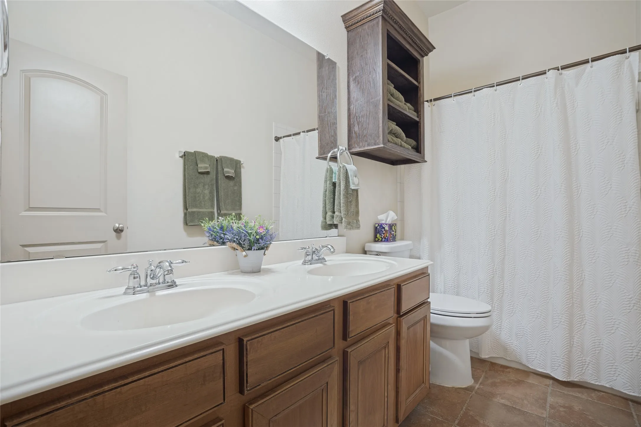 The conveniently located secondary bathroom offers a clean, functional space designed to accommodate family members and guests with comfort and ease.
