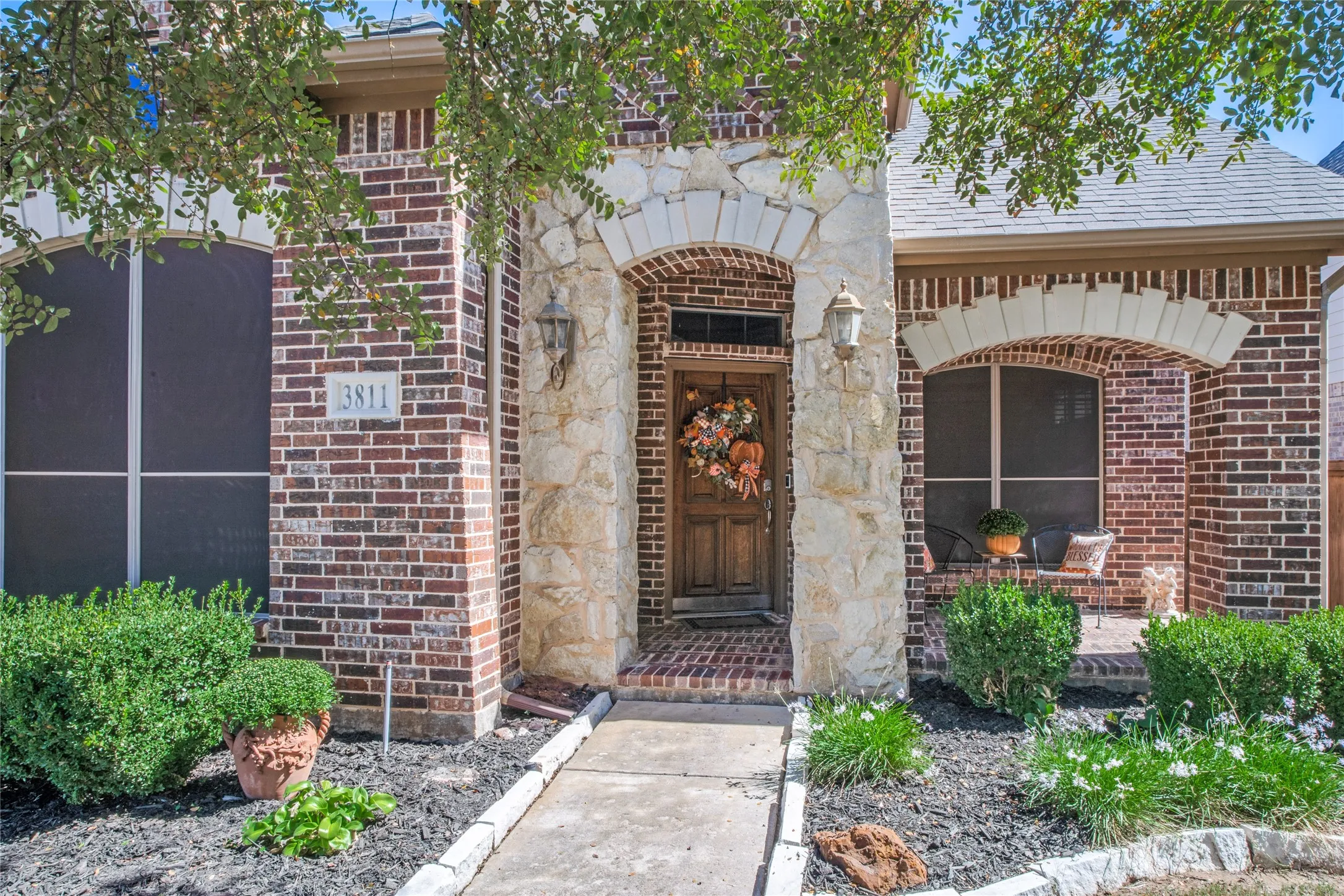 Freshly mulched flower beds adding a clean, polished touch to the inviting exterior.