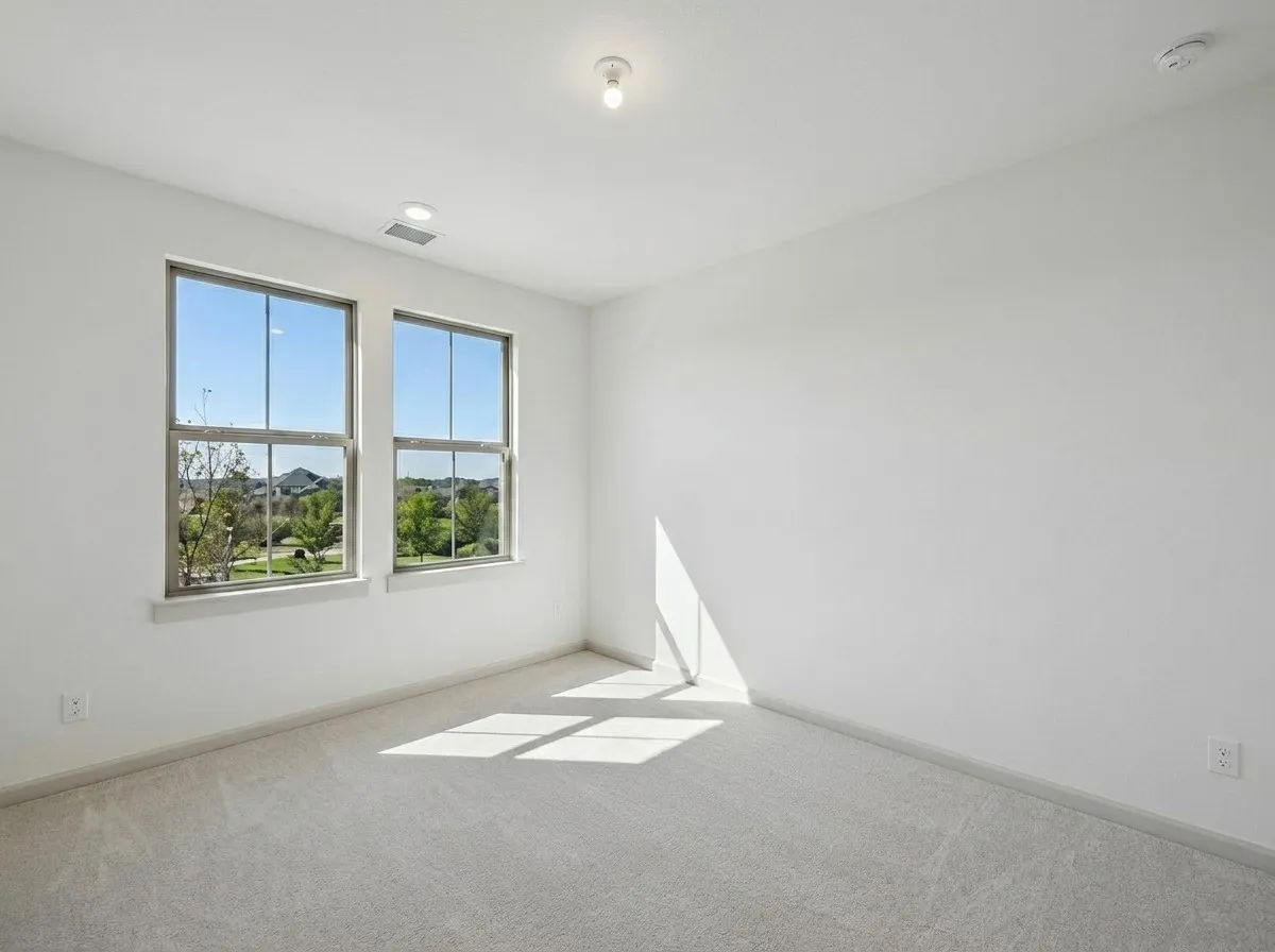 Dual windows, recessed lighting, ceiling-mounted light fixture, wall outlet, and plush carpeting