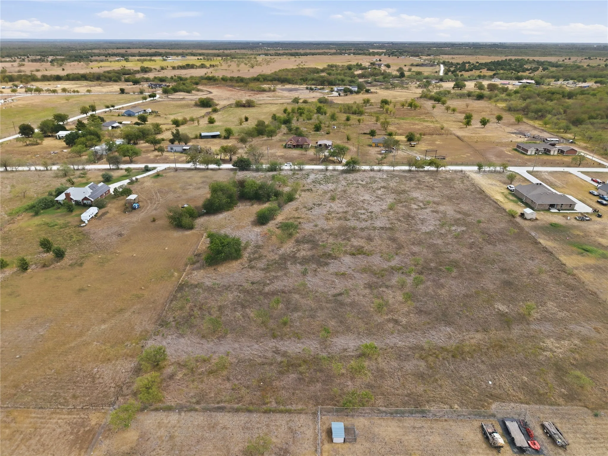 Expansive land parcel featuring natural terrain and scattered trees