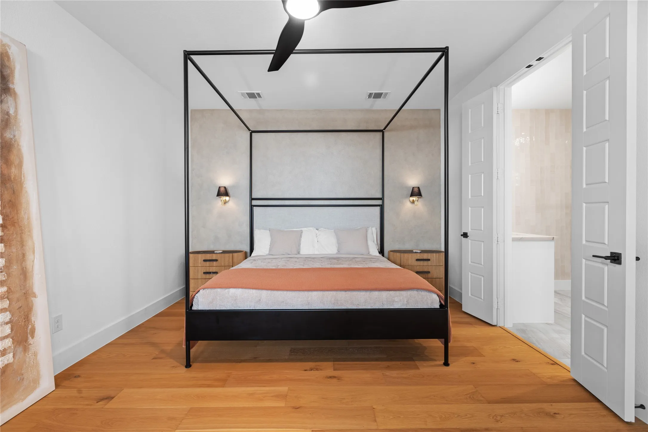 Hardwood flooring, recessed lighting, ceiling fan, architectural wall sconces, and double panel doors