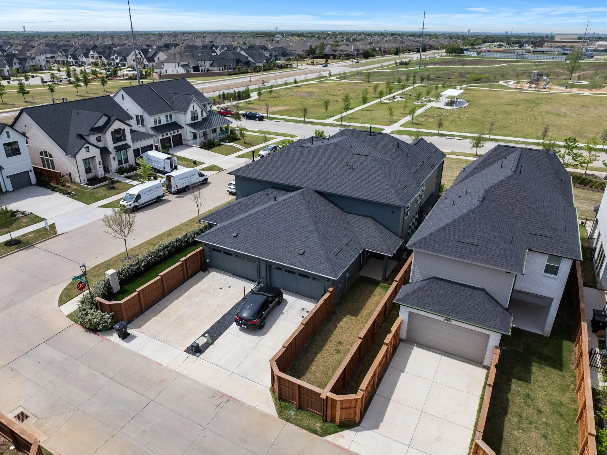 Contemporary exterior featuring dark gray siding and a gray shingle roof