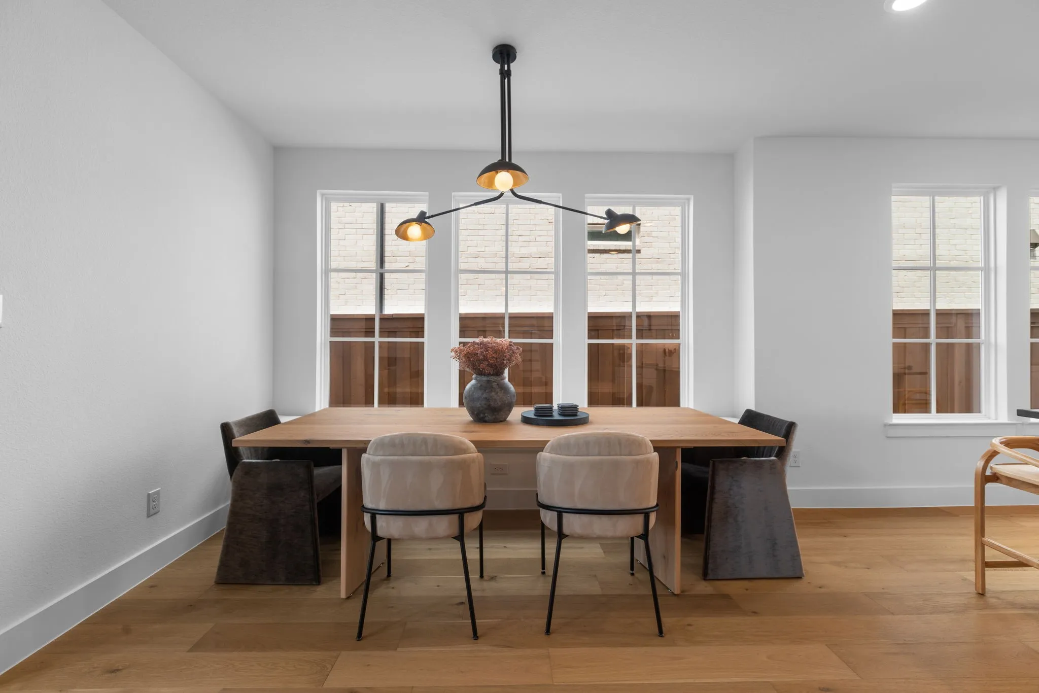 White walls with recessed lighting and a modern chandelier