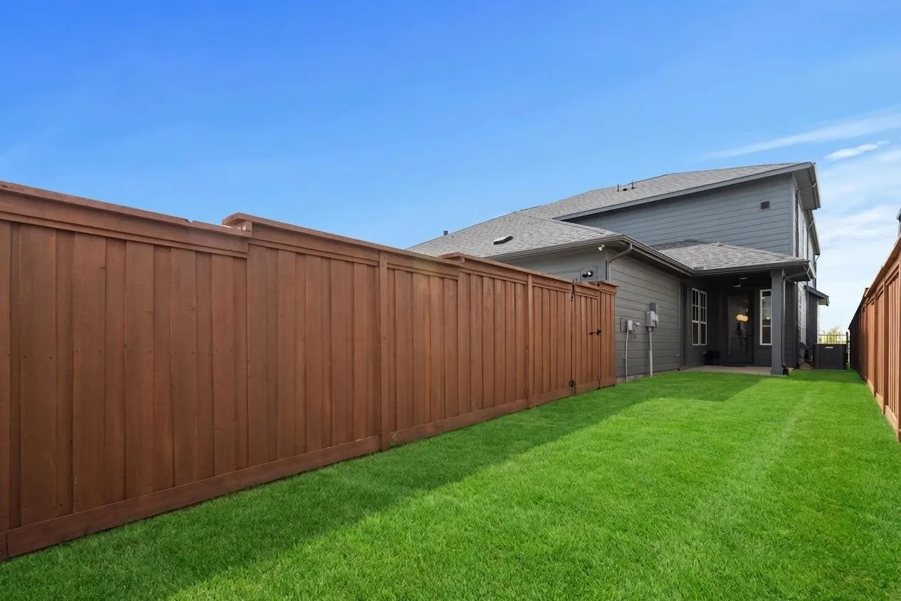 Manicured lawn with wood privacy fencing