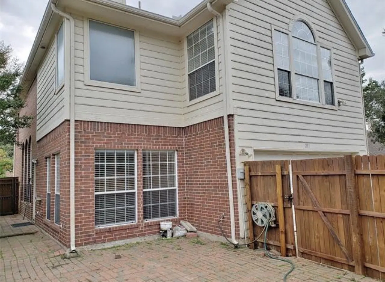Brick and siding exterior with multiple windows