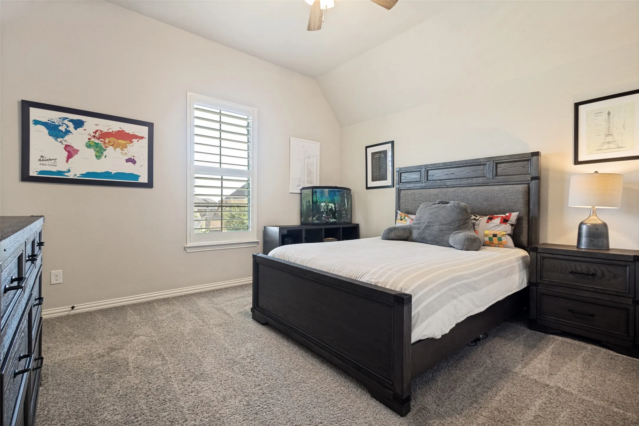 Bedroom featuring neutral-toned walls, vaulted ceiling, and gray carpet flooring