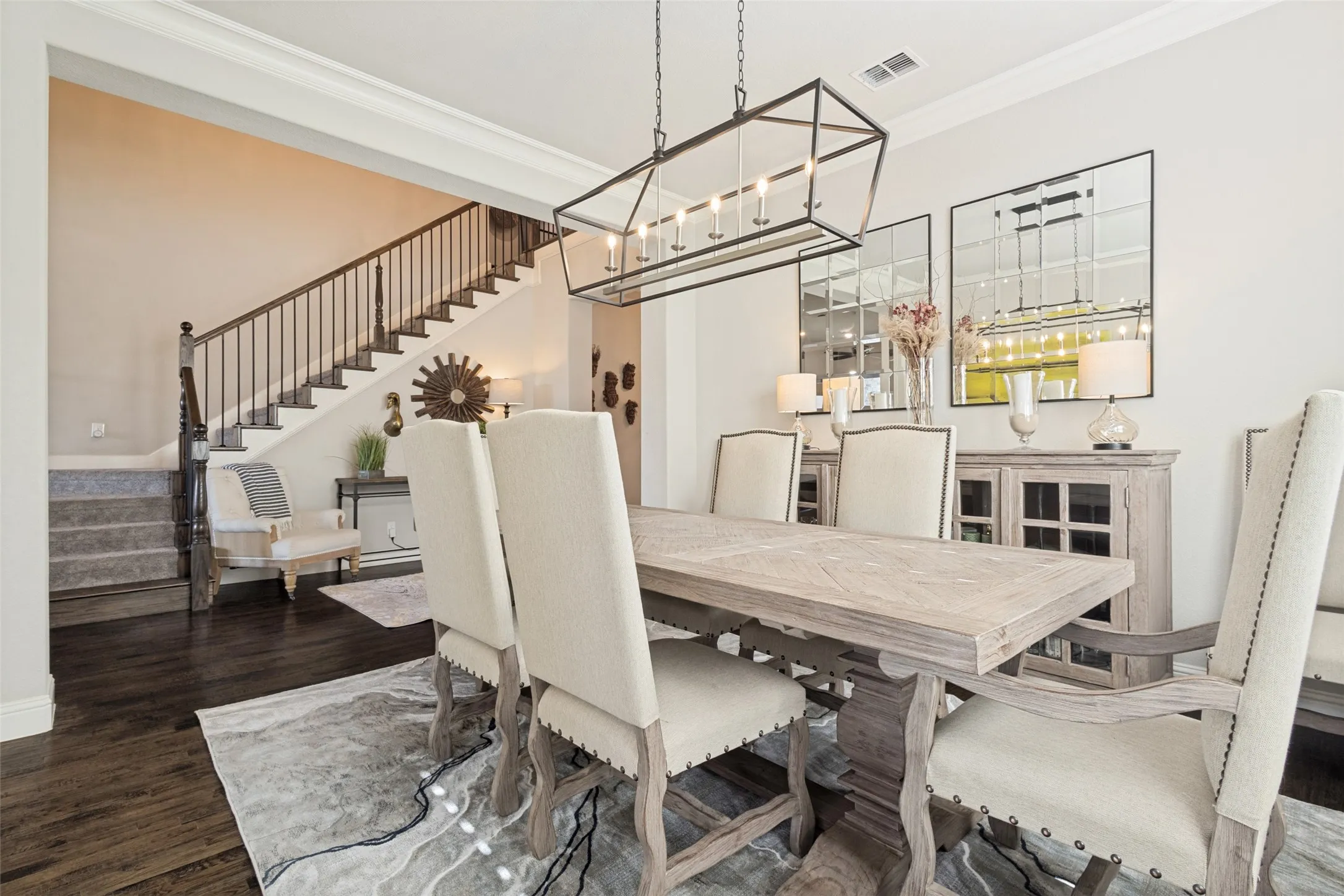 Dining area with dark wood-finish flooring, a linear chandelier, and a built-in sideboard with glass-front doors