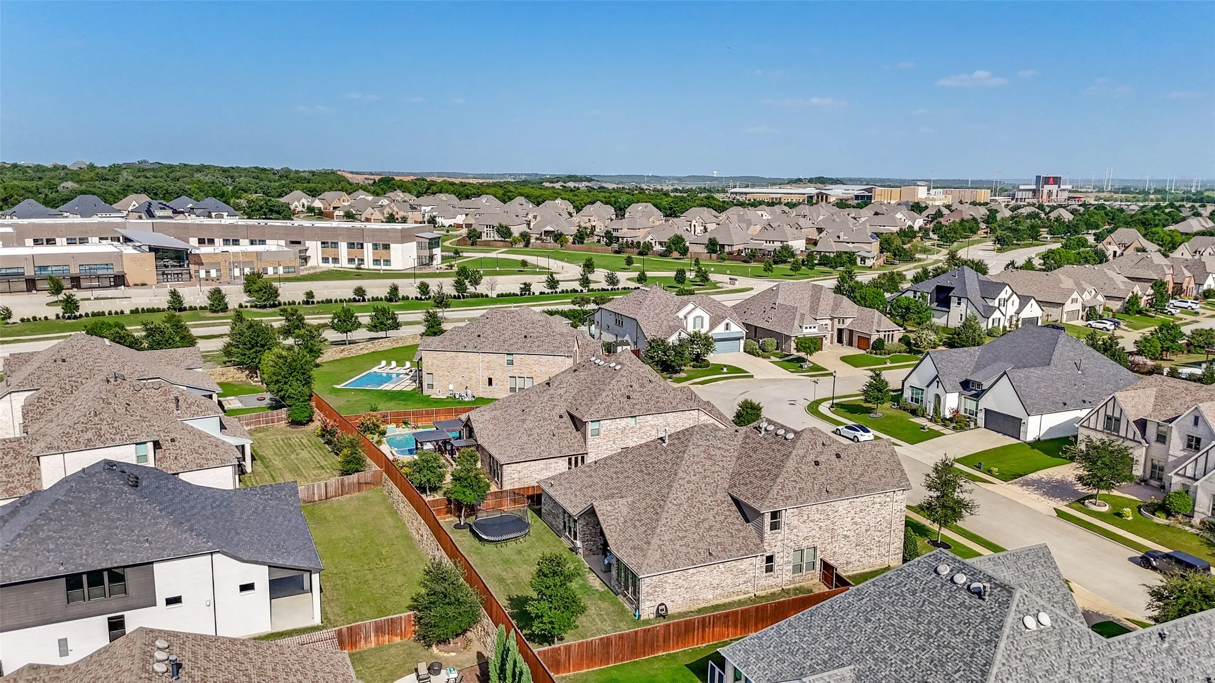 Expansive neighborhood showing the elementary school to the upper left, and the high school and stadium to the upper right of the photo