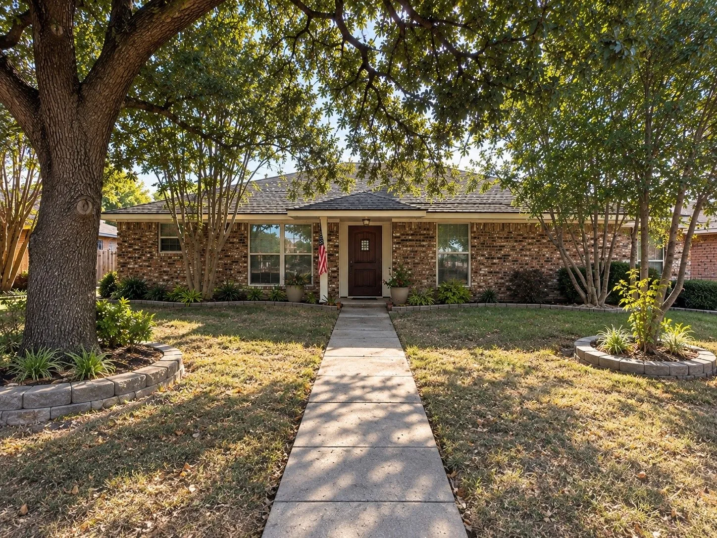 Welcome home! Charming single-story home framed by mature trees and established landscaping.