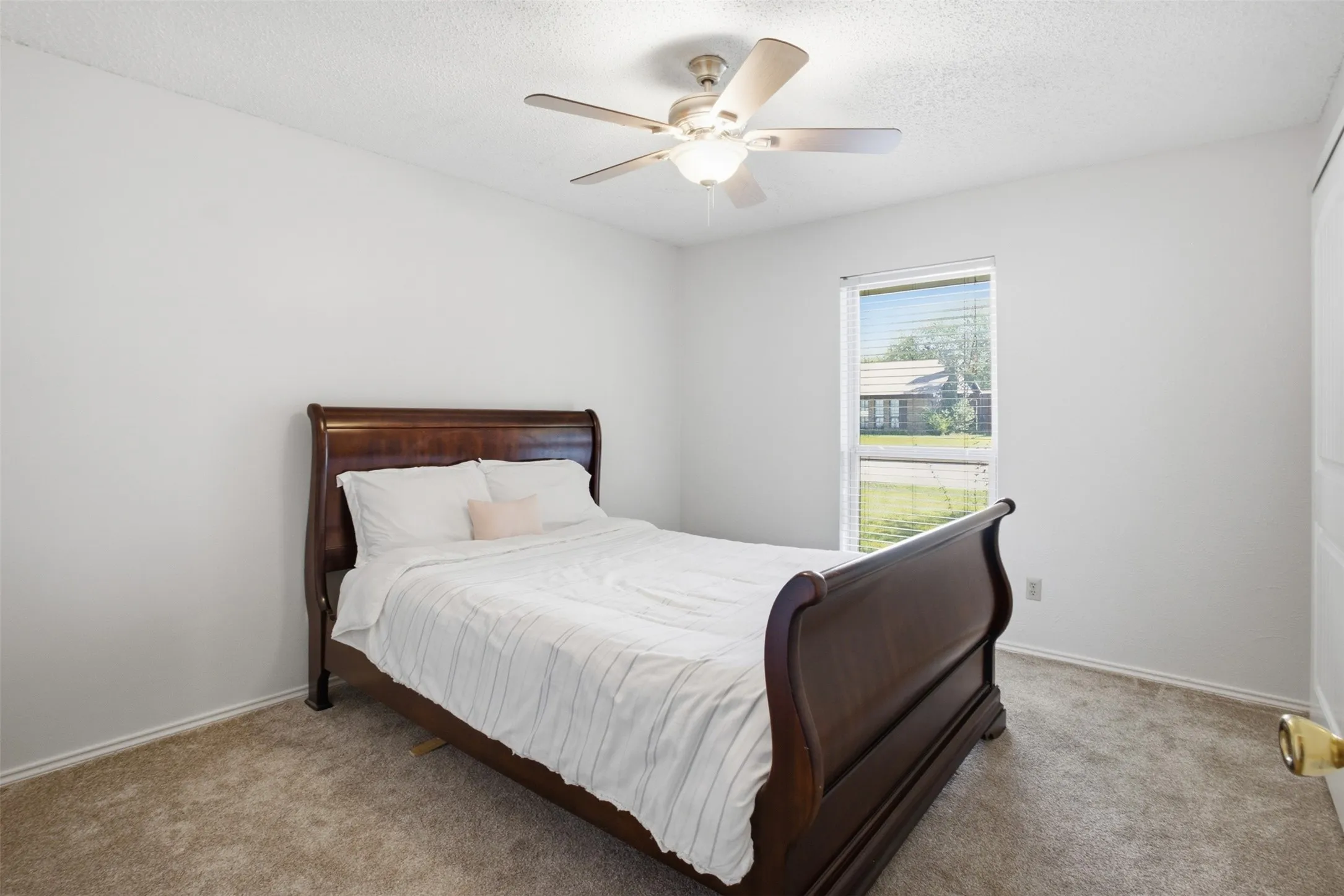 A second inviting bedroom with natural light and a walk-in closet of its own.